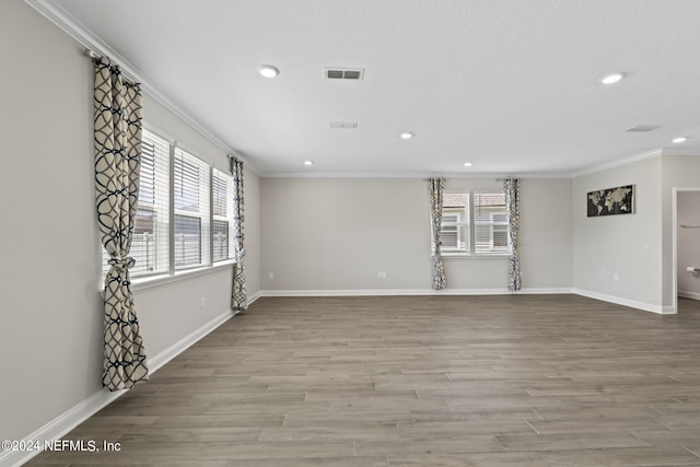 unfurnished living room featuring light hardwood / wood-style flooring and ornamental molding