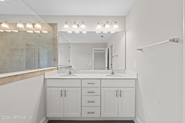 bathroom with vanity and a shower with door