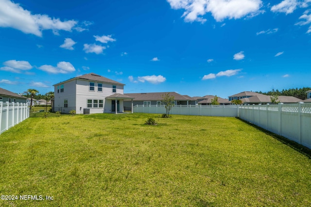 back of property featuring a lawn