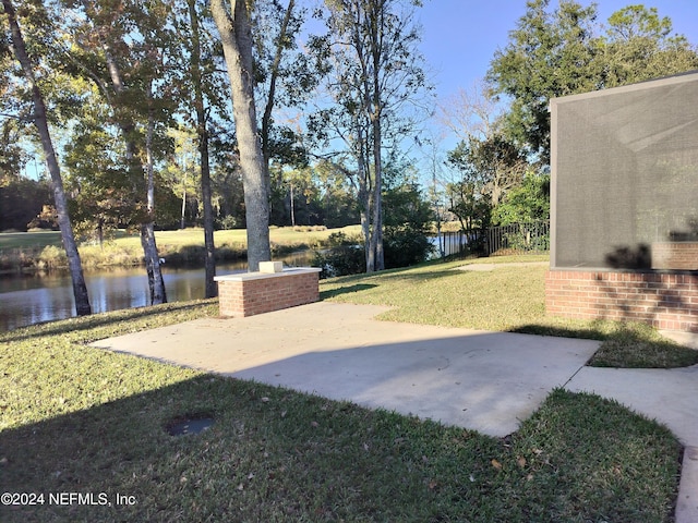 view of yard with a patio and a water view