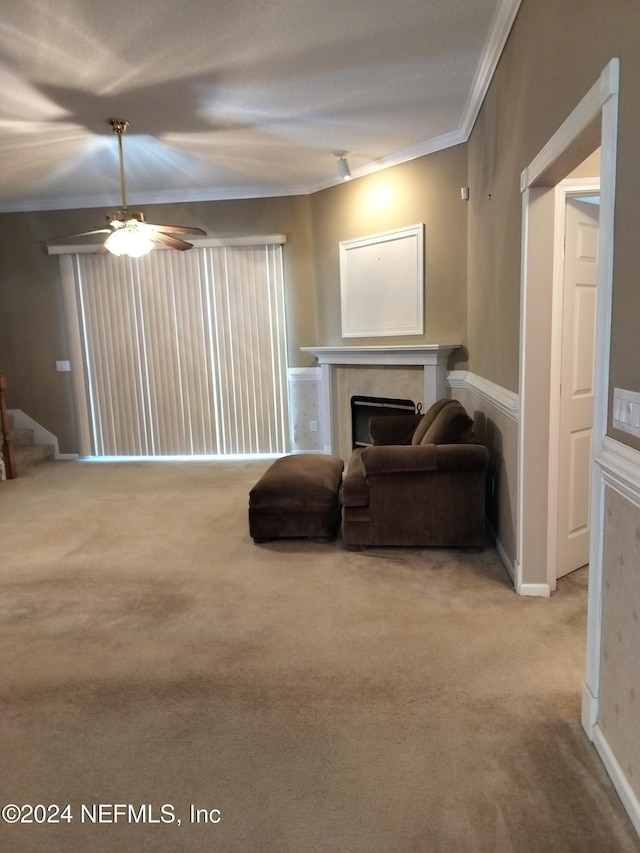 living room featuring ceiling fan, light carpet, and ornamental molding