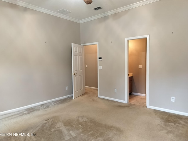 2546 Willow Creek Dr, Fleming Island, FL 32003 - unfurnished bedroom featuring ornamental molding, light carpet, and connected bathroom