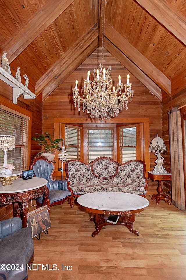 dining area with wood walls, plenty of natural light, light hardwood / wood-style floors, and beam ceiling