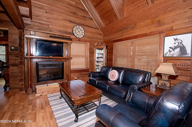 living room featuring wood walls, wooden ceiling, high vaulted ceiling, light hardwood / wood-style flooring, and beamed ceiling