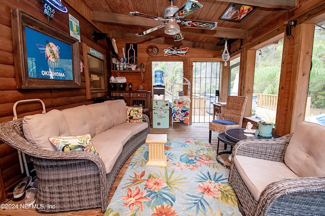 living room with wooden ceiling, vaulted ceiling with beams, ceiling fan, log walls, and wood-type flooring