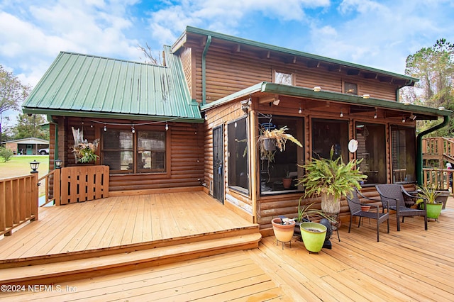 wooden deck with a sunroom