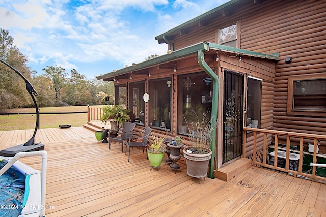 wooden terrace featuring a sunroom