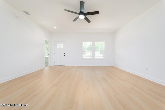 unfurnished living room featuring ceiling fan and light hardwood / wood-style floors