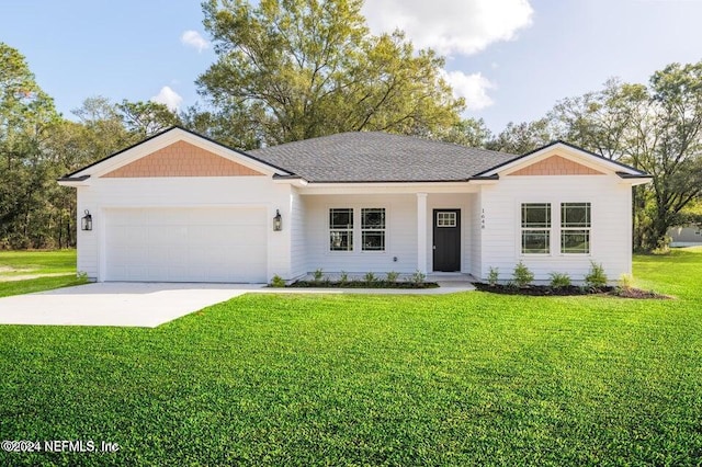 ranch-style house featuring a garage and a front lawn