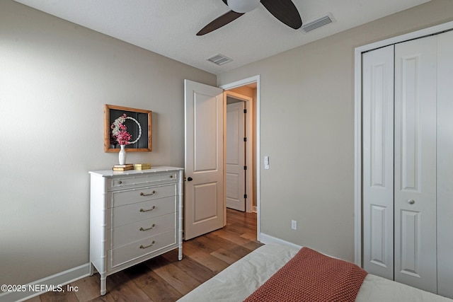 bedroom featuring a closet, ceiling fan, and dark wood-type flooring