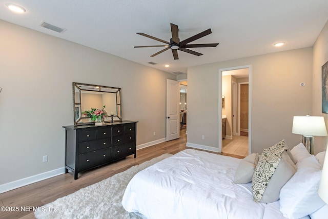 bedroom featuring ensuite bath, ceiling fan, and hardwood / wood-style floors