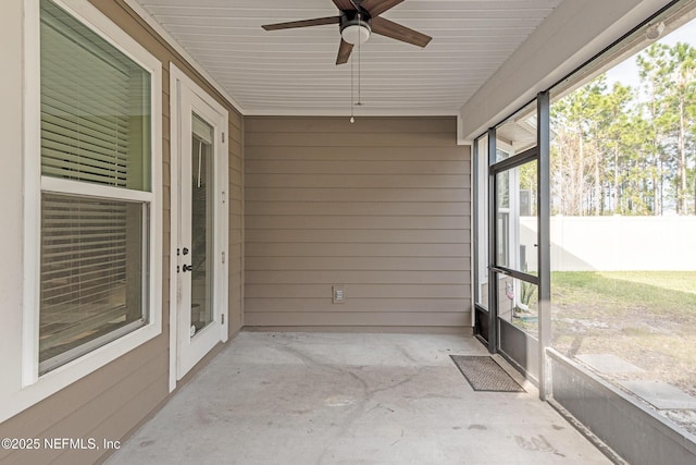 unfurnished sunroom with ceiling fan