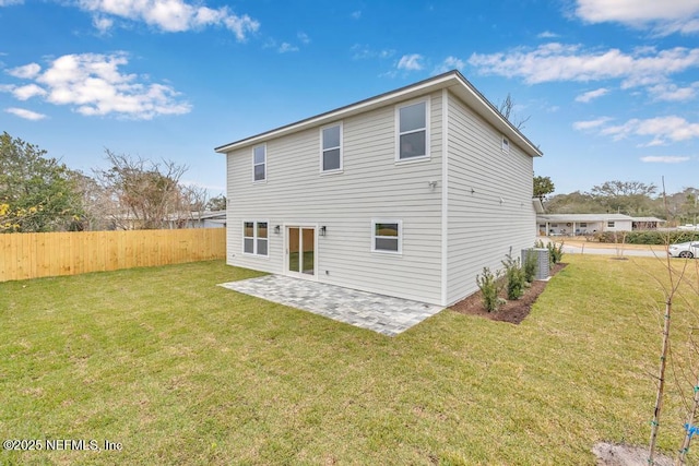 back of property with cooling unit, a patio area, and a lawn