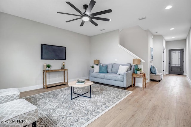 living room featuring ceiling fan and light hardwood / wood-style floors