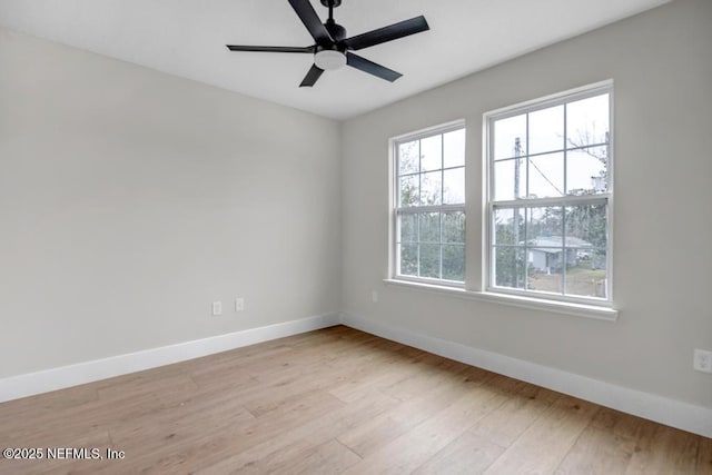 empty room with light hardwood / wood-style flooring and ceiling fan