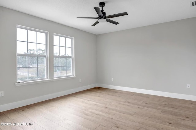 empty room with light hardwood / wood-style flooring and ceiling fan