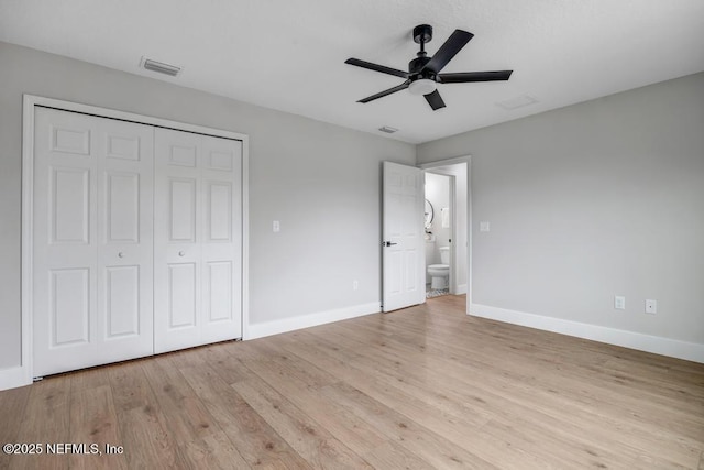 unfurnished bedroom featuring ceiling fan, light hardwood / wood-style floors, and a closet