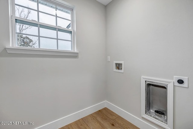 washroom featuring wood-type flooring, hookup for an electric dryer, and hookup for a washing machine