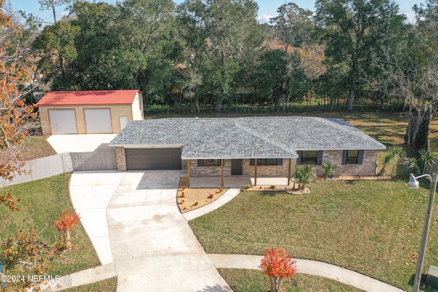 view of front of home with a porch, a garage, and a front lawn