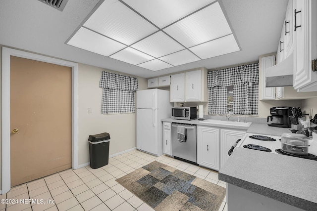 kitchen featuring premium range hood, sink, light tile patterned floors, appliances with stainless steel finishes, and white cabinetry