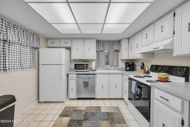 kitchen featuring light tile patterned floors, white appliances, white cabinetry, and sink