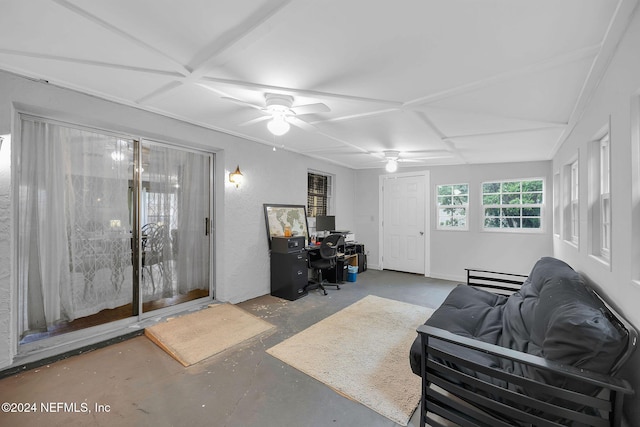 living room with ceiling fan and concrete floors