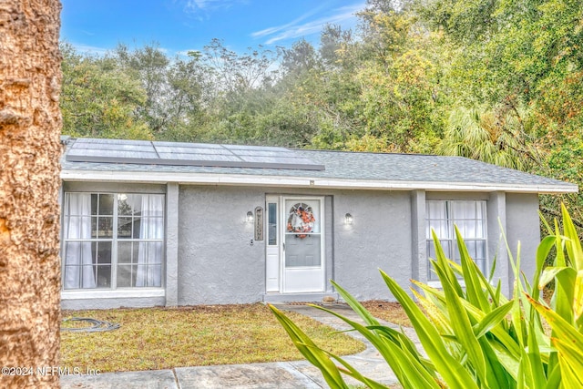 1 Farrington Ln, Palm Coast, FL 32137 - doorway to property with stucco siding and a shingled roof