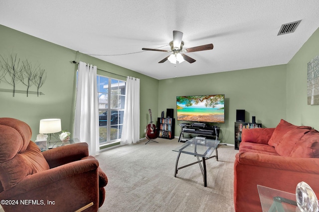 living room with ceiling fan, light carpet, and a textured ceiling