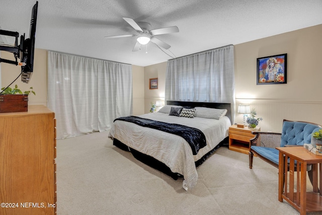 1 Farrington Ln, Palm Coast, FL 32137 - carpeted bedroom featuring a ceiling fan, a textured ceiling, and wainscoting