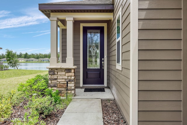 entrance to property with a water view