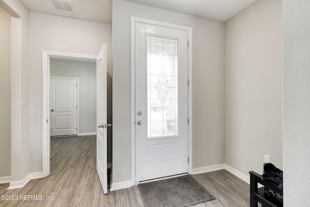 foyer entrance with light hardwood / wood-style floors