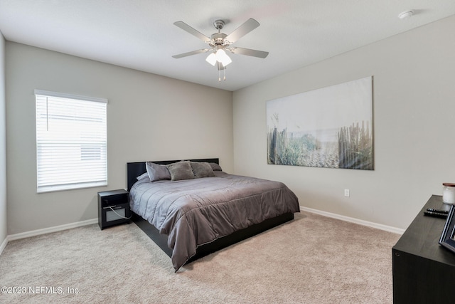 bedroom featuring light colored carpet and ceiling fan