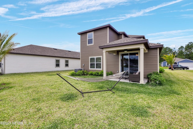 rear view of property with a yard, a patio area, and central air condition unit