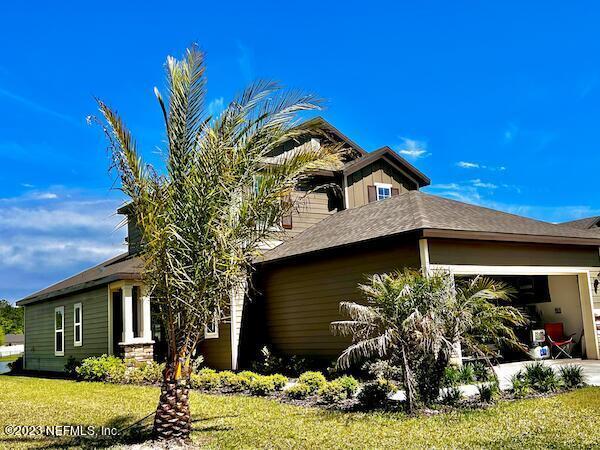 view of side of property with a yard and a garage