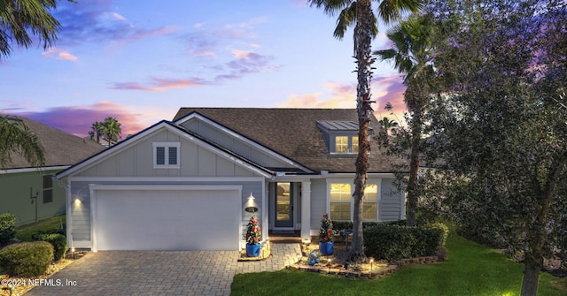 view of front facade with a garage and a lawn