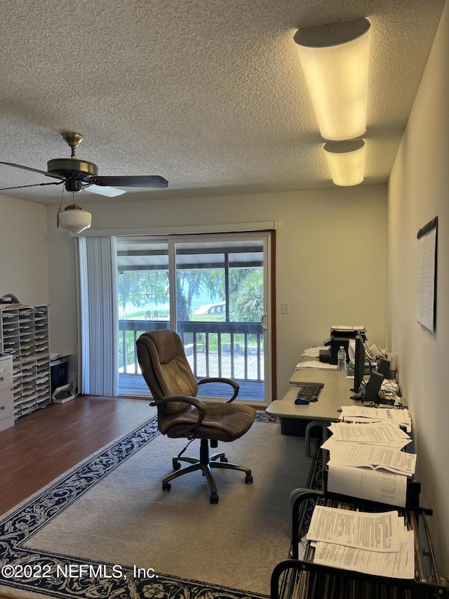 office featuring ceiling fan, wood-type flooring, and a textured ceiling