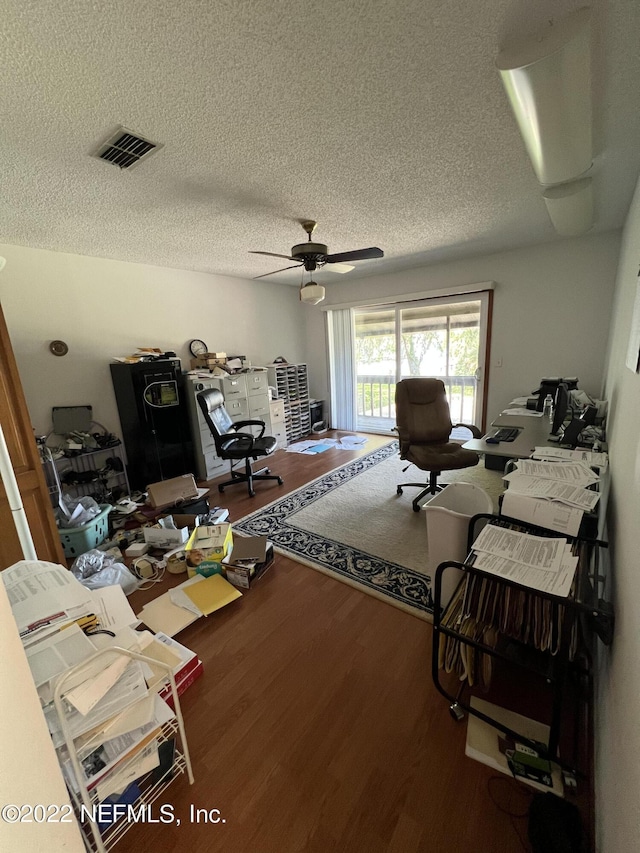 office area featuring hardwood / wood-style flooring, ceiling fan, and a textured ceiling