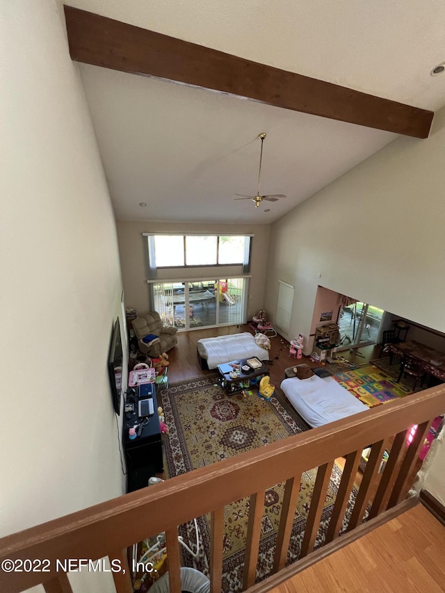 living room with lofted ceiling, ceiling fan, and wood-type flooring