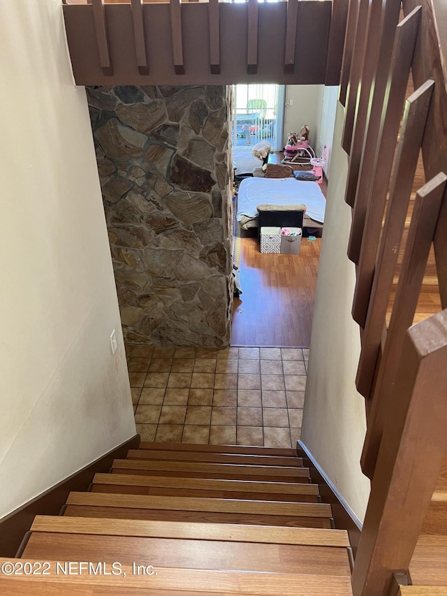 staircase with hardwood / wood-style flooring