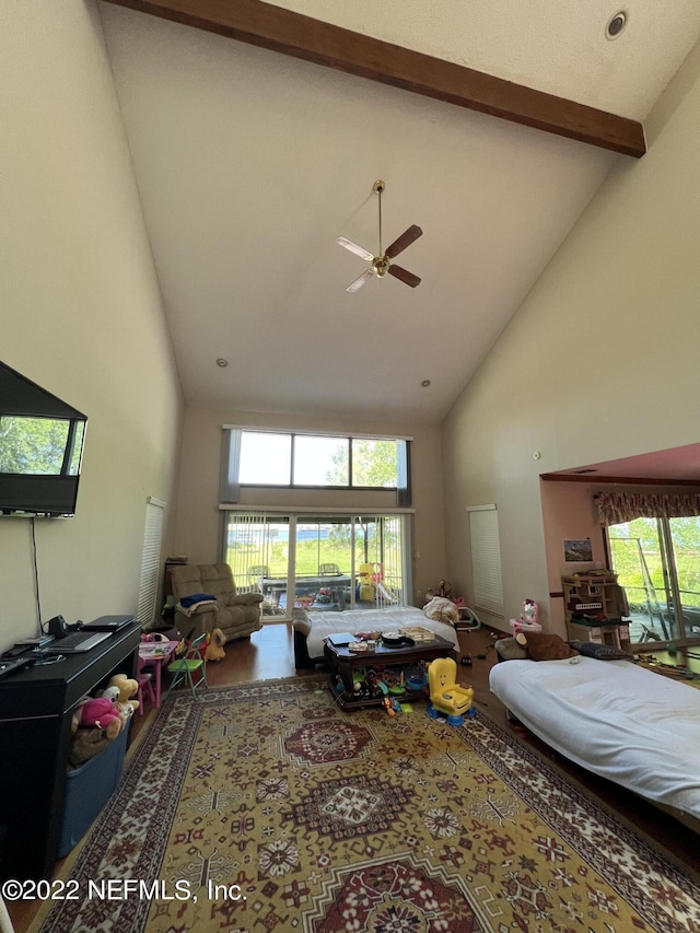 living room with beam ceiling, ceiling fan, and high vaulted ceiling