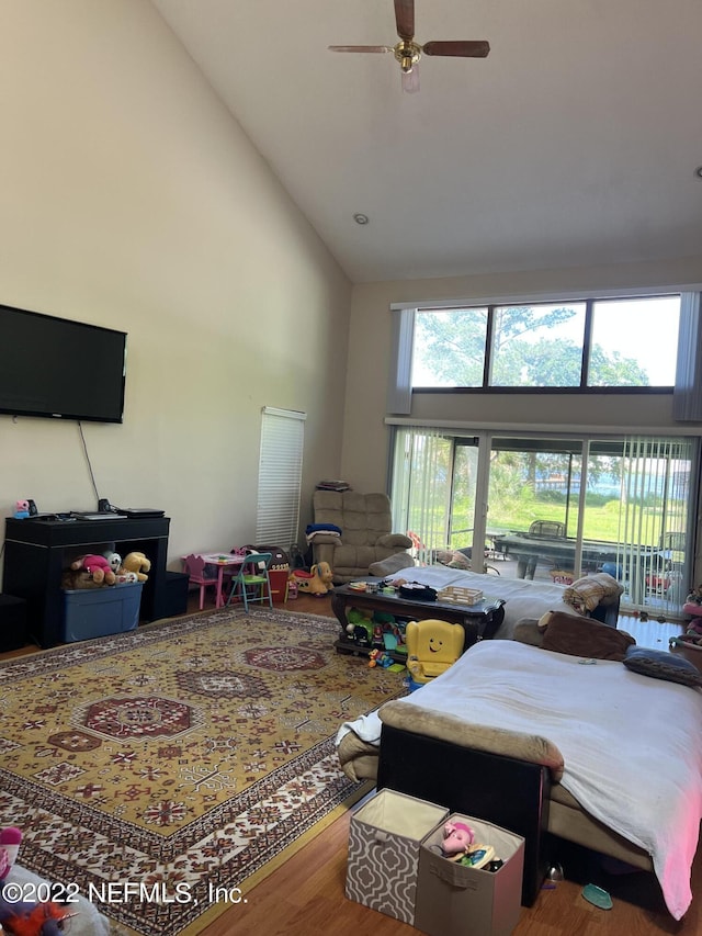 bedroom with wood-type flooring, high vaulted ceiling, and ceiling fan