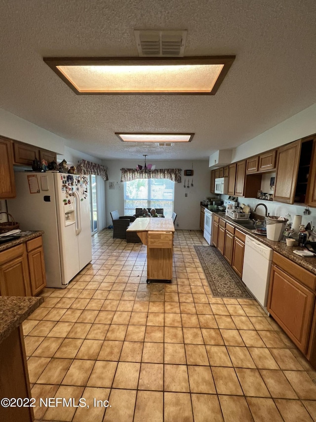 kitchen featuring sink, billiards, a textured ceiling, white appliances, and light tile patterned floors