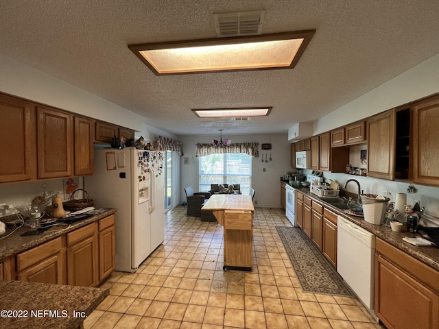 kitchen featuring sink, hanging light fixtures, billiards, a textured ceiling, and white appliances