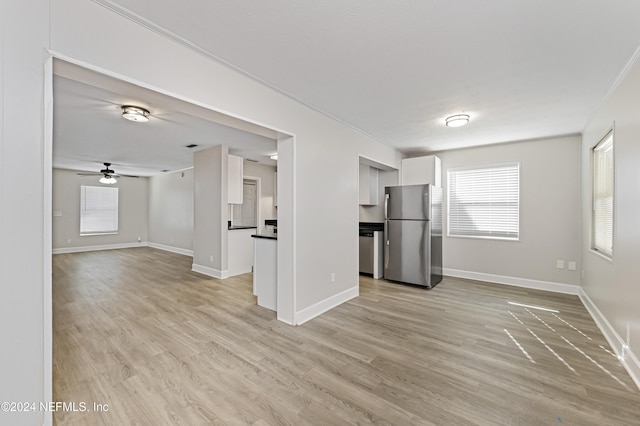 unfurnished living room with ceiling fan and light hardwood / wood-style floors