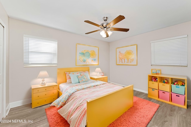 bedroom with wood-type flooring and ceiling fan