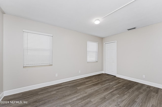 spare room with dark hardwood / wood-style flooring