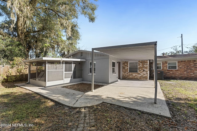 back of house with a sunroom and central AC unit