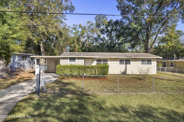 ranch-style house featuring a front lawn and a carport