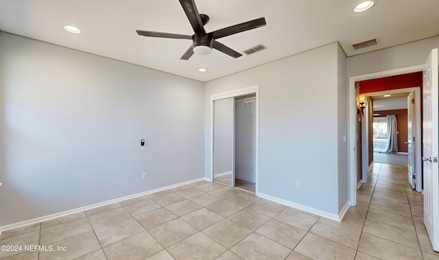 unfurnished bedroom featuring a closet, ceiling fan, and light tile patterned flooring