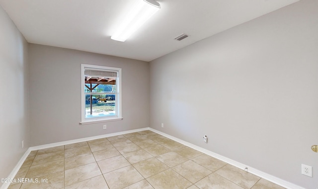 unfurnished room featuring light tile patterned floors